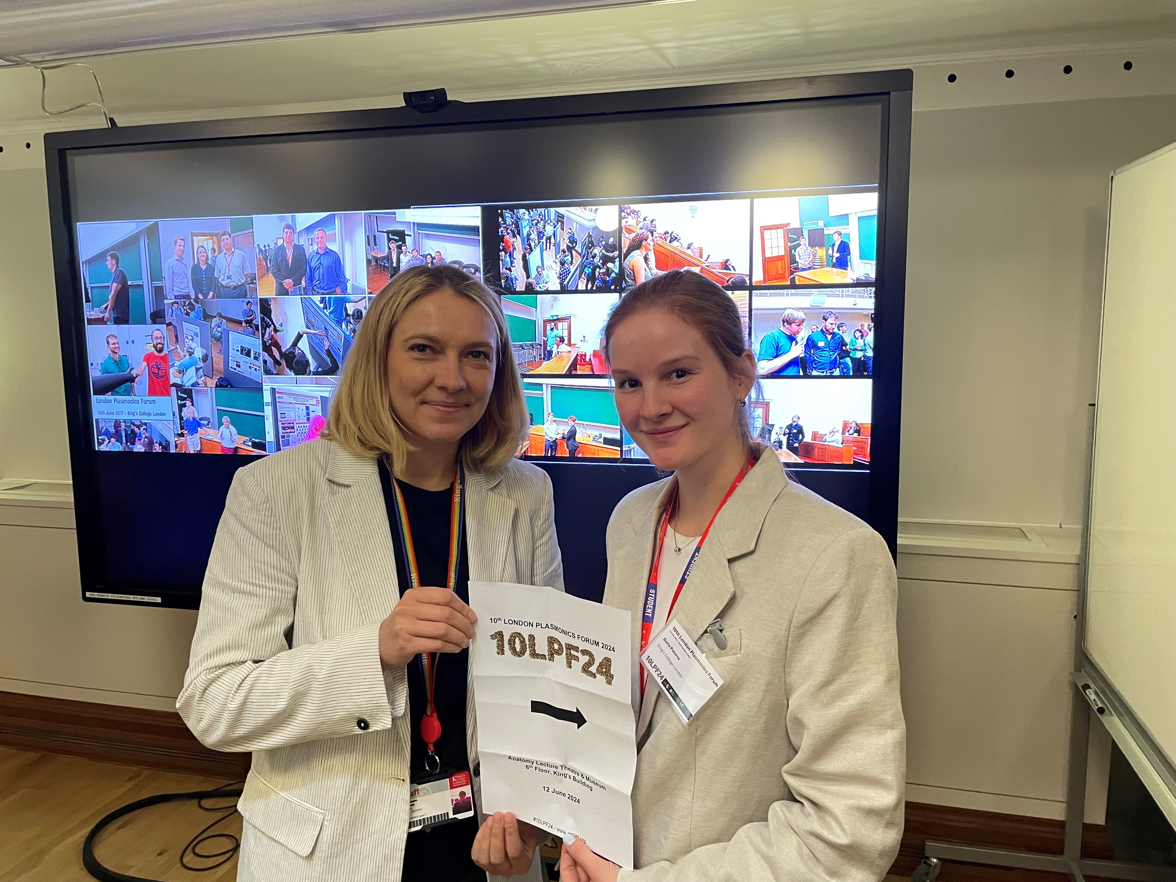 A photo of Sasha and Daria holding the prize announcement sheet